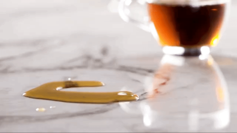 Personne qui essuie du café sur du Dekton